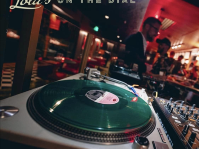 a record spinning on a turntable with the Lola's bar in the background (photo courtesy of Lola's Madison)