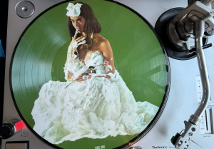 "Whipped Cream and Other Delights" pictograph LP on a record player