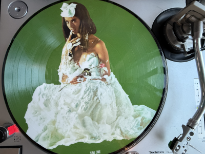 "Whipped Cream and Other Delights" pictograph LP on a record player